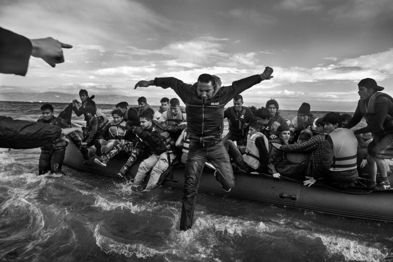©Ashley Gilbertson, Volunteers help refugees, primarily from Syria, Iraq and Afghanistan, disembark on the island of Lesbos, Greece, near Turkey, 2016, courtesy of Monroe Gallery of Photography